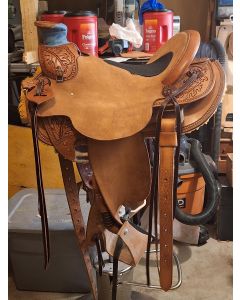 1/4 tooled with oakleaf and inlaid seat. Stirrup leathers are twisted and wrapped. 